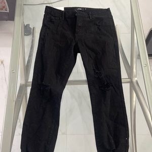 Black slightly high rise distressed . Never worn